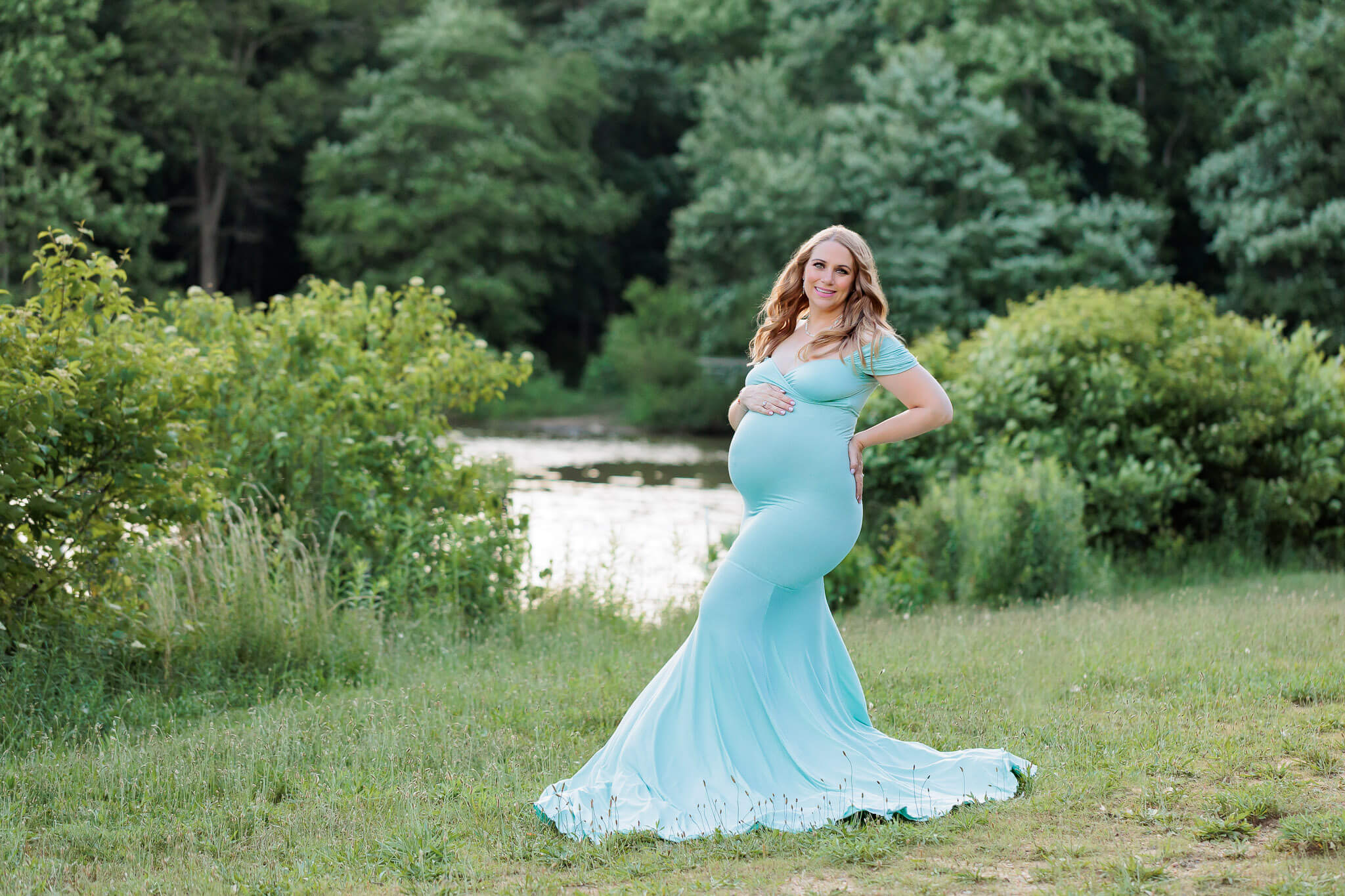 Mother-to-be in a teal dress featured in a blog about Northern Virginia pediatricians.