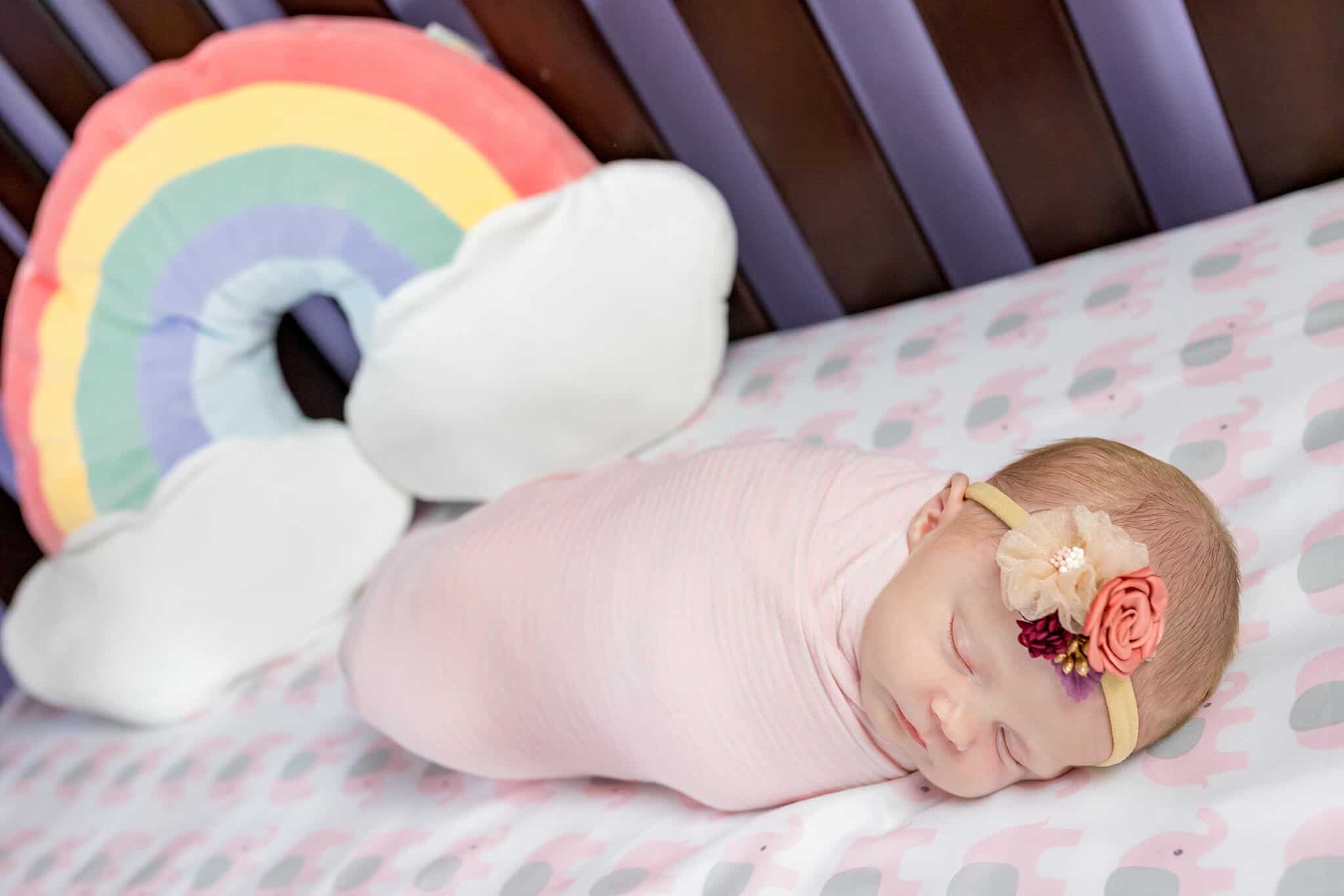 A newborn baby girl wrapped up in her crib featured on a blog about Northern Virginia pediatricians.
