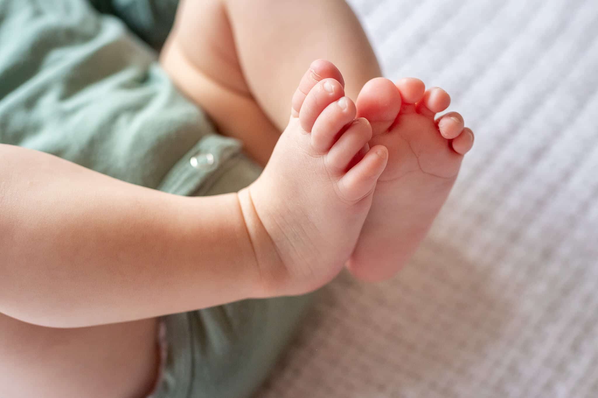 A close-up of a baby's toes featured on a blog about Bellies and Babies Consignment.