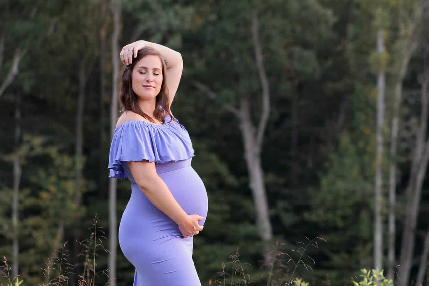 A blog about prenatal yoga Northern Virginia featuring a beautiful mother-to-be posing in the woods.