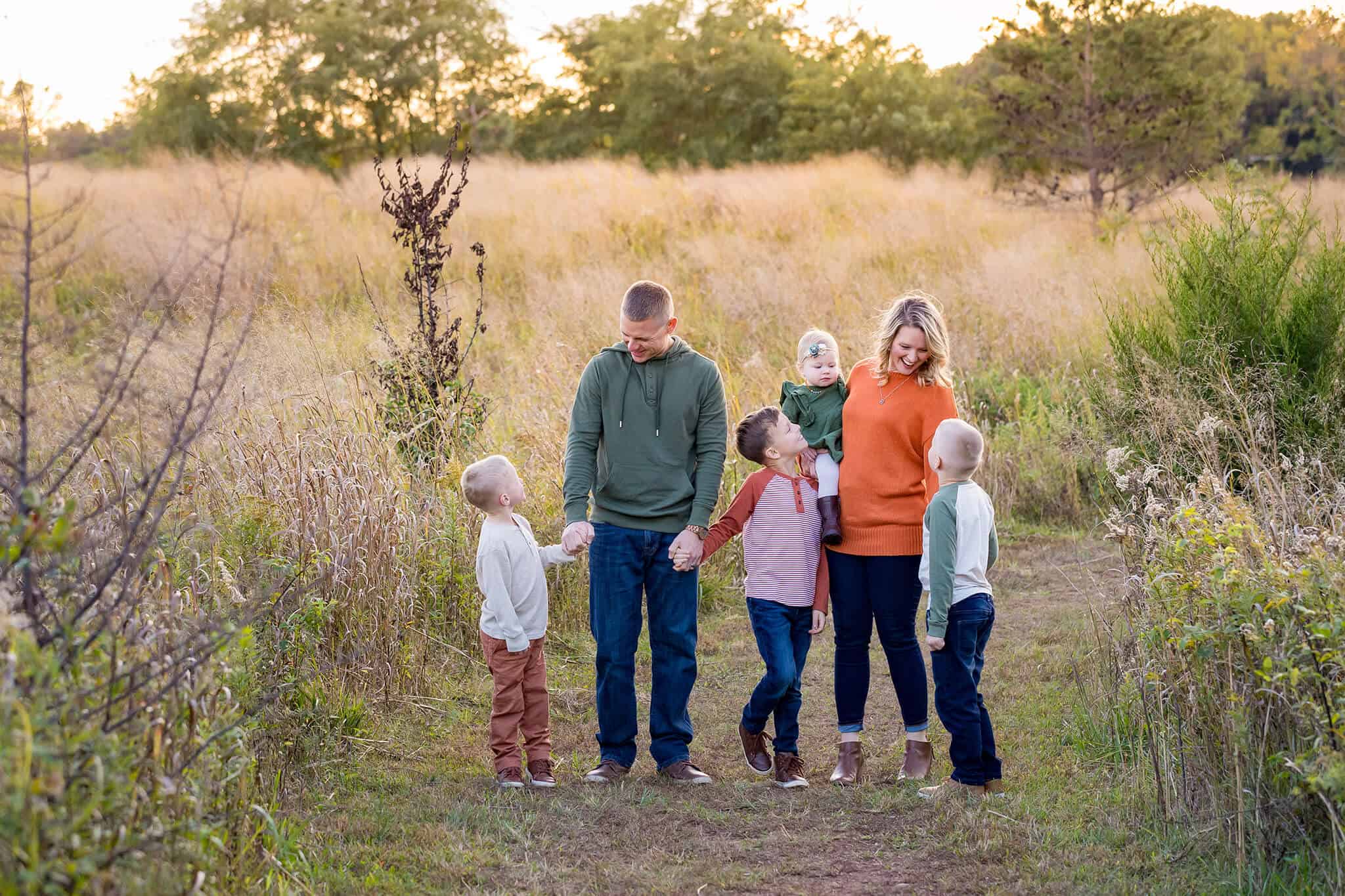 A family of six standing in a field featured on a blog about Red Barn Mercantile.