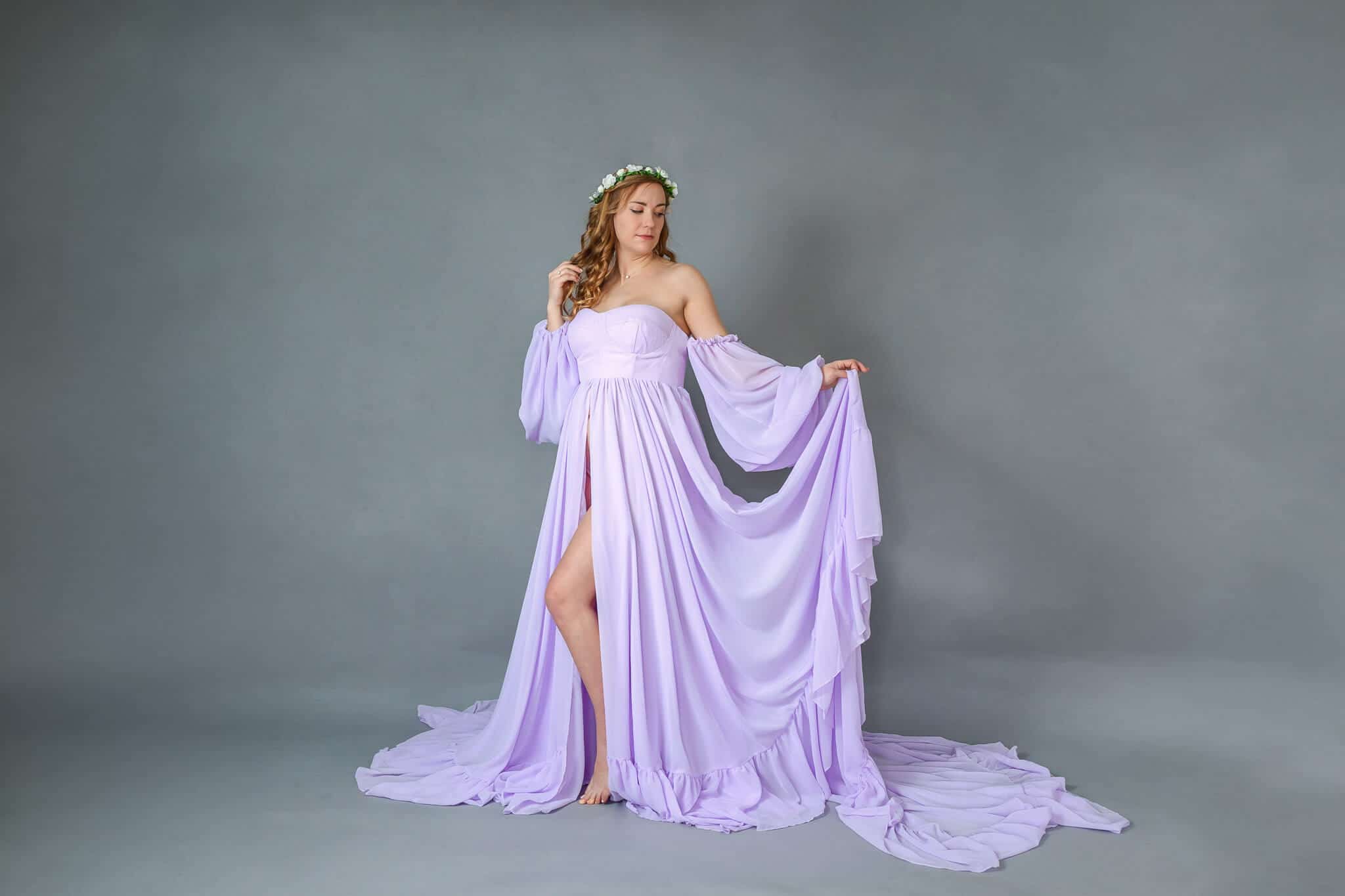 A pregnant woman in a lavender gown posing in studio, featured on a blog about Washington DC OBGYN.