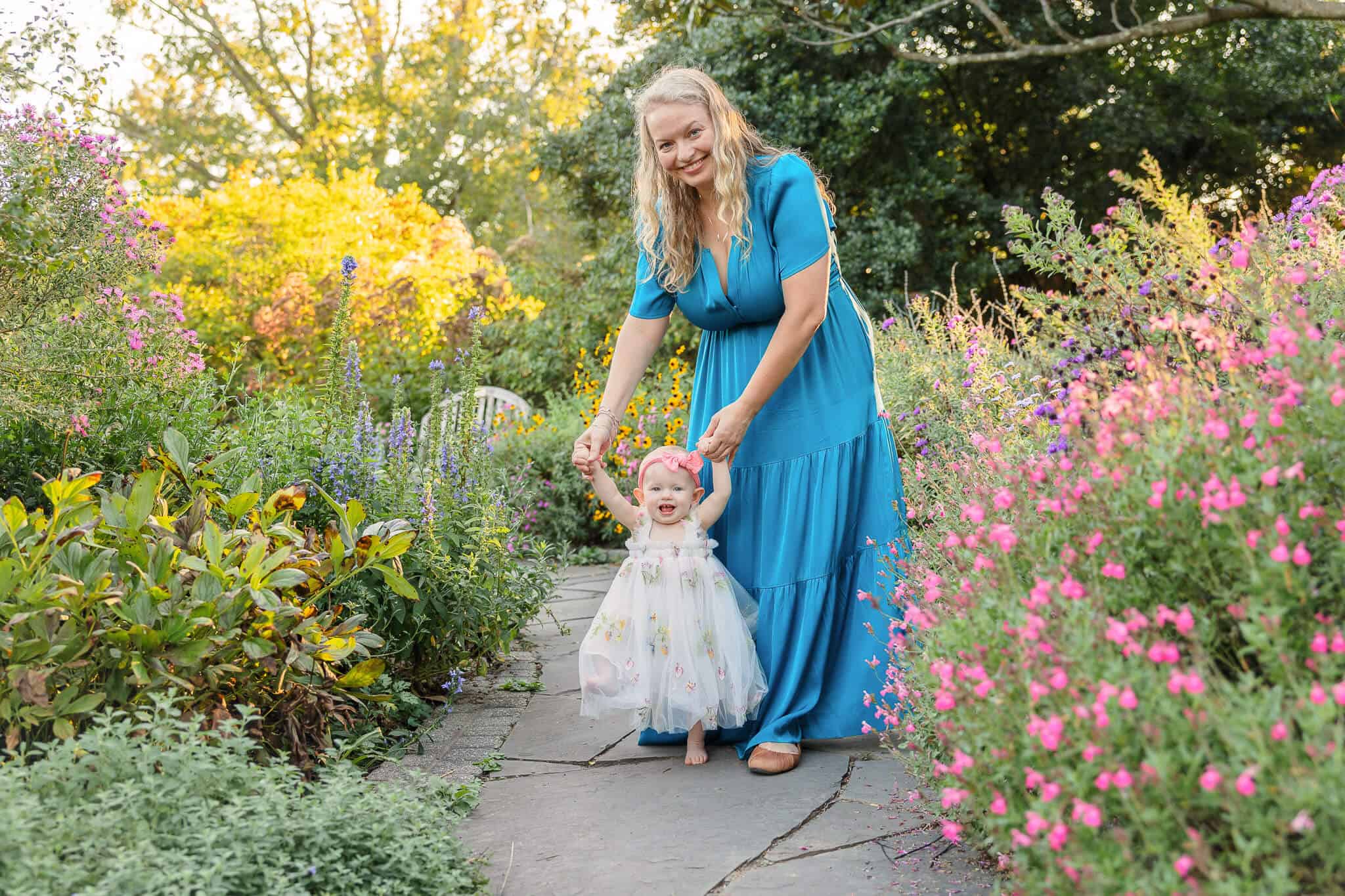 A mom and her baby girl exploring a flower garden at one of my favorite photoshoot locations in Northern Virginia.